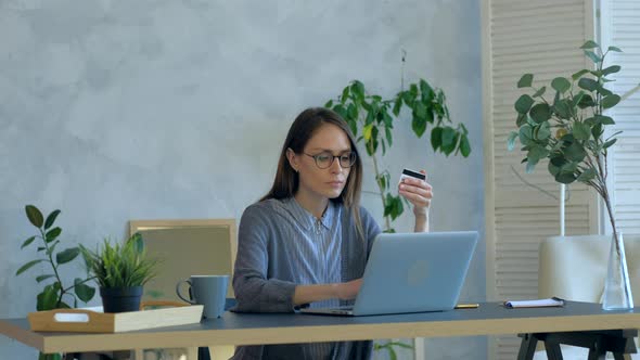 Female Buying Online Shopping By Card in Interior, Using Notebook at Day Time.