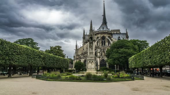 Beautiful Garden Near Notre-Dame De Paris Cathedral, Thick Grey Clouds in Sky
