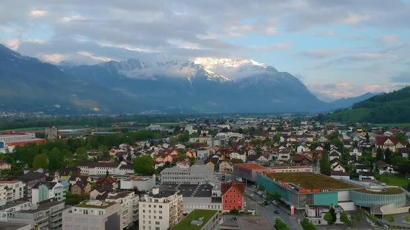 Scenic Mountains Towering Over Swiss Town During Sunrise In Switzerland, Europe. Aerial Wide Shot