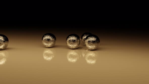 Mechanical Collision Of Golden Balls On A Glossy Surface.