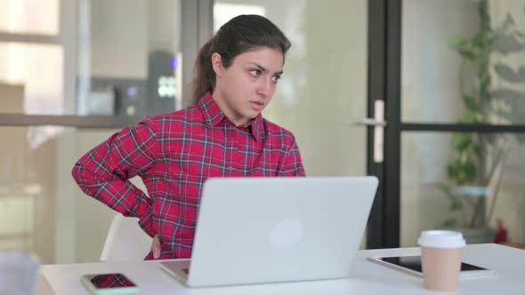 Indian Woman Having Back Pain While Using Laptop