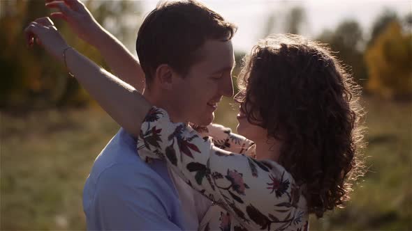 Young Couple in Love Walking on Meadow in Summer - Togetherness Concept.