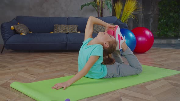 Flexible Girl Performing King Cobra Pose at Home