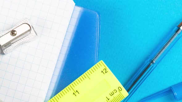 School Supplies Lie on a Pastel Blue Background Together with