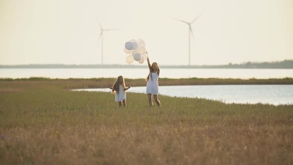 Mom with Daughter and Balloons Walk