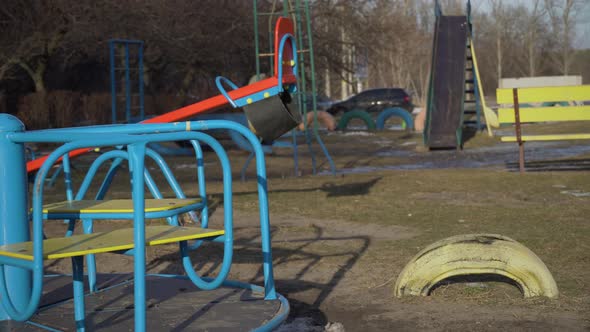 Empty Swing is Spinning on the Playground in the Yard