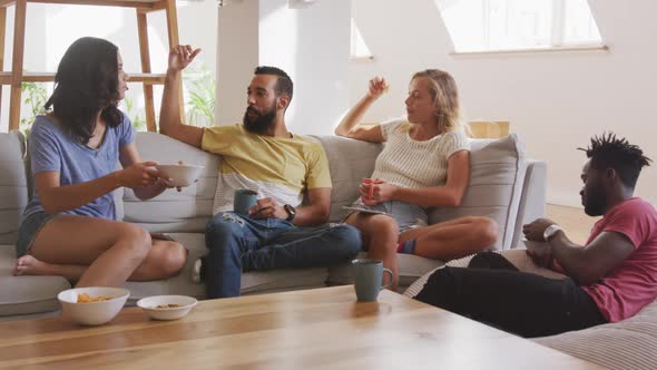 Two couples having breakfast together at home