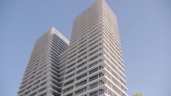 An Office Building in an Urban Area  View From Below  the Clear Blue Sky in the Background