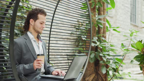 Young successful caucasian businessman works in a lounge using a computer.