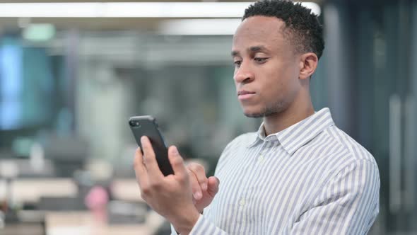 African Businessman Celebrating on Smartphone