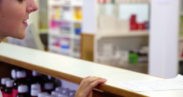 Pharmacist assisting the medicine to customer
