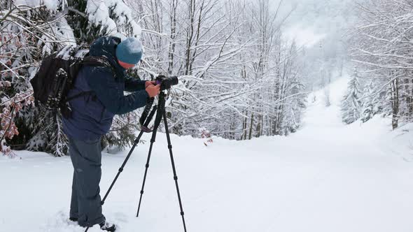 The Photographer Shoot a Mountain Forest in the Carpathians in Rainy and Snowy Weather