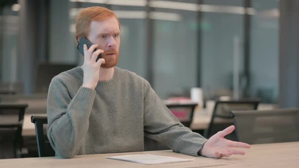 Young Man Talking Angrily on Smartphone