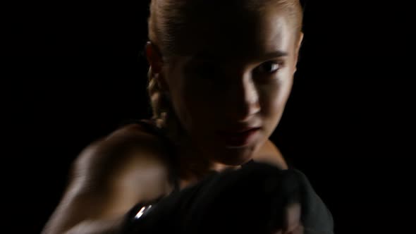 Silhouette of a Beautiful Woman Boxer Throwing Punches. Close Shot