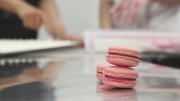 Delicious Pink Raspberry Macaroons on the Table at Commercial Kitchen