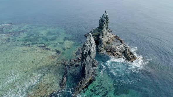 Aerial Orbital View of High Sea Stacks High Rocky Cliff Pillars and Transparent Turquoise Sea Waters