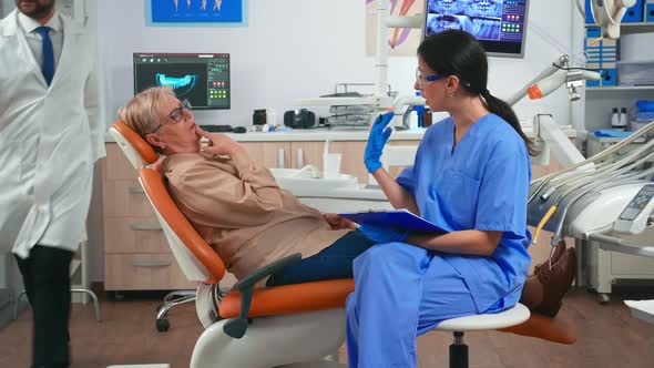 Nurse Taking Notes About Patient Dental Problems