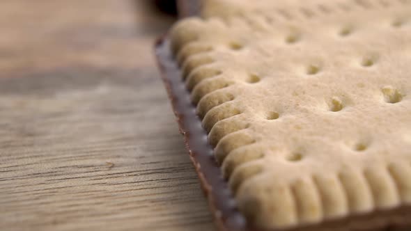 Crispy biscuits with a chocolate layer. On a wooden rustic surface.