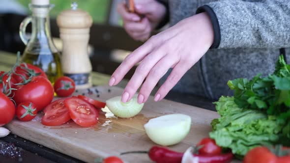 Woman Slicing Onions Making Vegetable Salad Outdoors