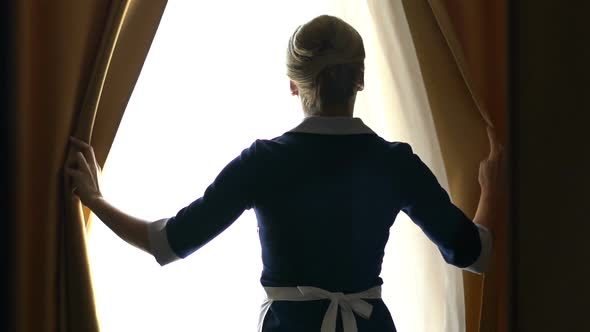 Chambermaid of Luxury Hotel Opening Curtains in Best Suit, Going to Clean Room