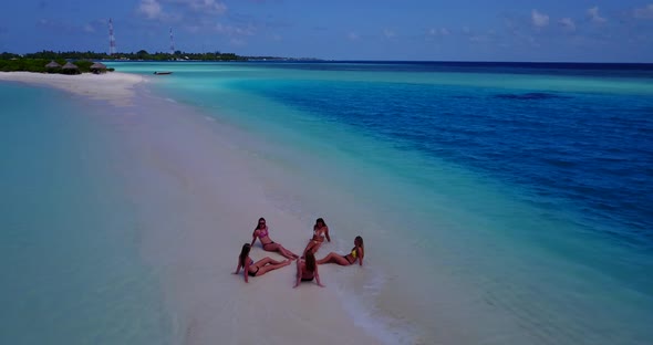Pretty happy ladies travelling by the sea on beach on paradise white sand and blue background 