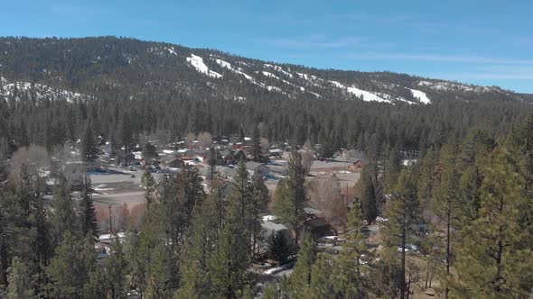 Drone shot over Big Bear California trees with a snow