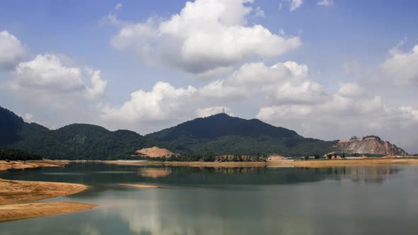 Moving cloud at dry soil and coconut tree at Mengkuang Dam.