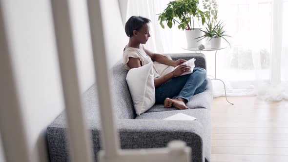 Solitary woman reading a book at home