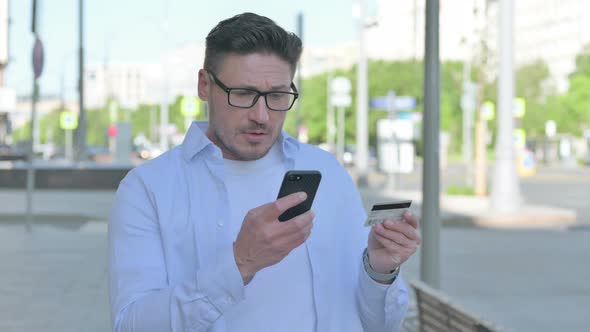 Man Having Online Payment Problem Via Smartphone Outdoor