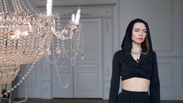 Sexy Young Woman in Black Gown is Posing in White Hall Dramatic Female Portrait Indoors