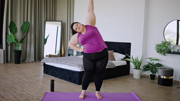 Young Fat Body Positive Woman Stretches Body Doing Yoga