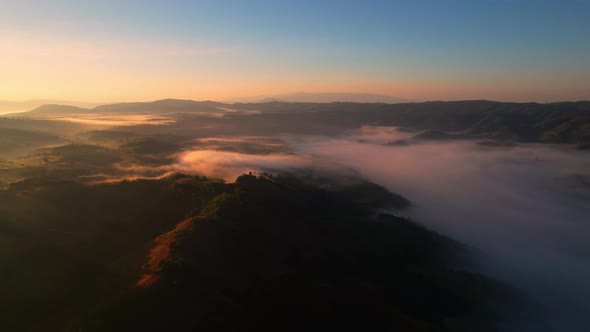 A sea of clouds above the valley and the mountains in the background