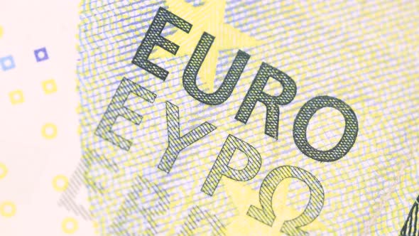 five euro bill surface detail of printed letters rotating, macro shot. Extreme close up, very close