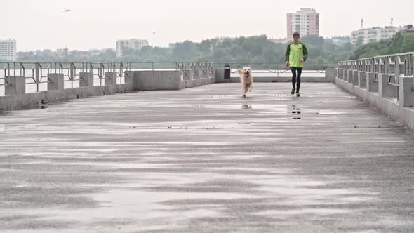 Teenage Boy Running with Lovely Dog