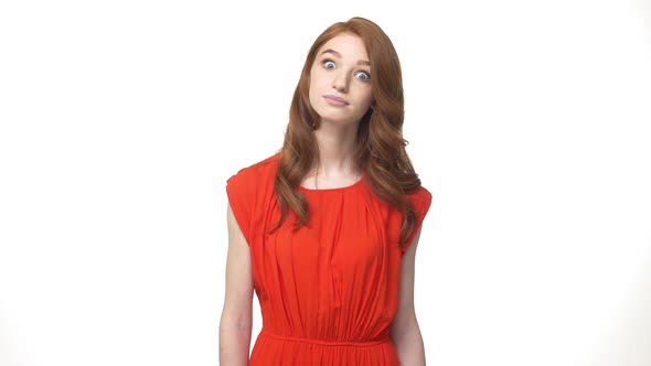 Happy Young Caucasian Redheaded Girl Standing and Saying Yes Isolated Over White Background.