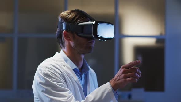 Caucasian male doctor wearing vr headset using virtual interface