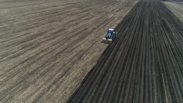 Aerial view of a blue tractor plant potatoes. 03