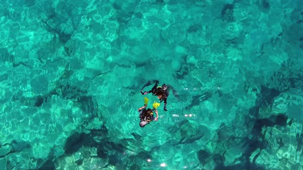 Aerial View of Divers Swimming Underwater Sea