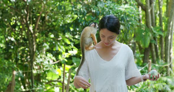 Woman tourist go to the park for visit  Squirrel Monkey