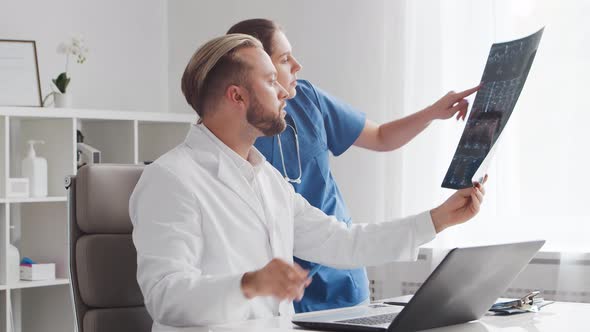 Professional medical doctors working in hospital office. Physician and the young nurse.