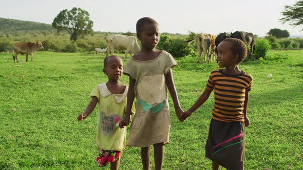 Maasai children holding hands and walking