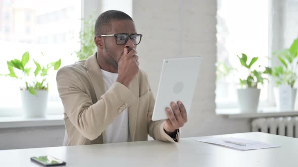 African Man Reacting to Loss on Tablet in Office