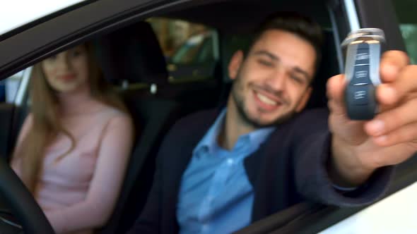 Man Shows Key Through the Car Window