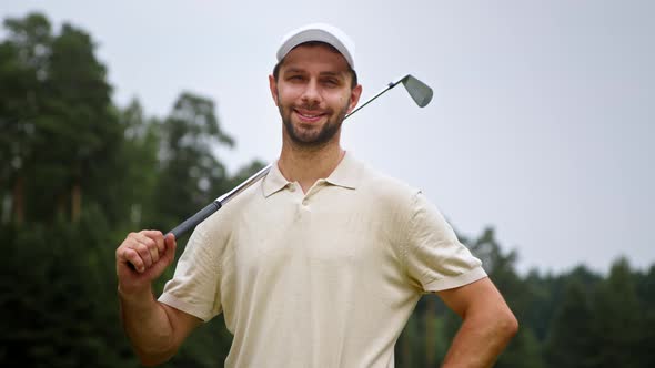 Portrait of a young golfer in uniform looking at camera