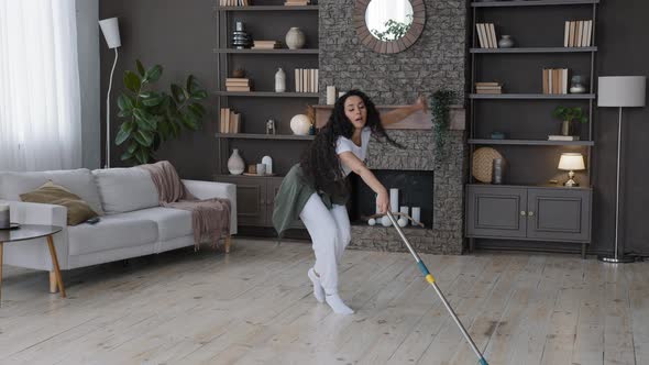 Energetic Happy Young Woman Housewife Mopping Floor in Living Room Performs Choreographic Movements