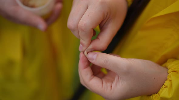 Female Hands Hooking Worm in Slow Motion on Fishing Rod Hook