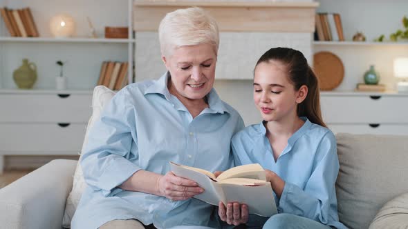 Smart Girl Granddaughter Reading with Grandma at Home