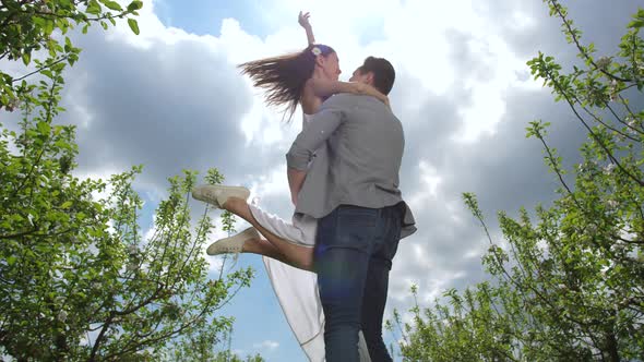 Joyful Couple Spending Leisure in Spring Orchard