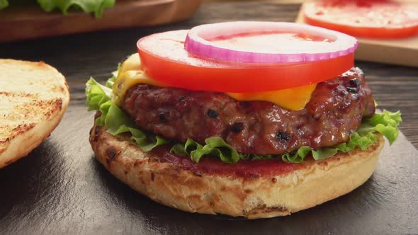 Onion Rings are Placed on the Top of the Fresh Homemade Grilled Burger