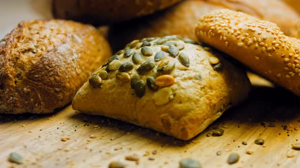 Different Kinds of Fresh Bread on Wooden Table